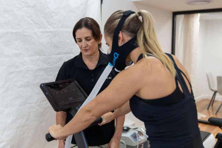 Personal trainer assisting a client with strength training and weight loss at Fortis Fit Personal Training in Sydney.